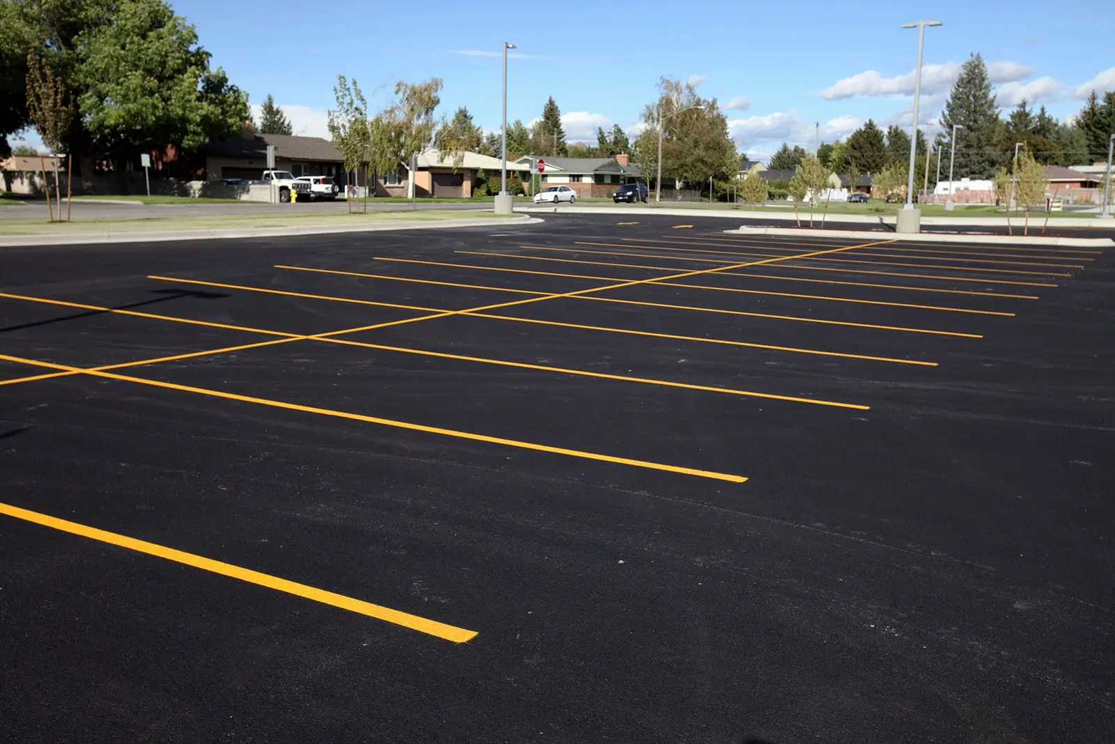 Same parking lot freshly seal coated with bright yellow striping